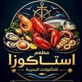 شعار مطعم استاكوزا في منيا القمح يظهر طبق مأكولات بحرية متنوع يضم استاكوزا وجمبري وأسماك.