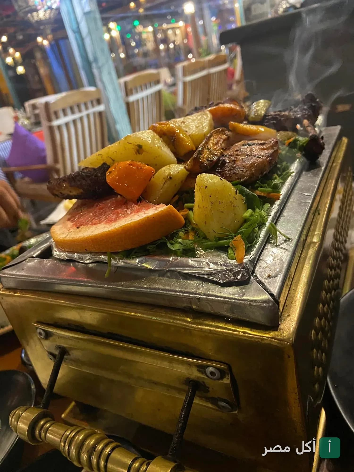طبق مشاوي ساخن يقدم على شواية معدنية صغيرة في مطعم علي بابا بدهب.