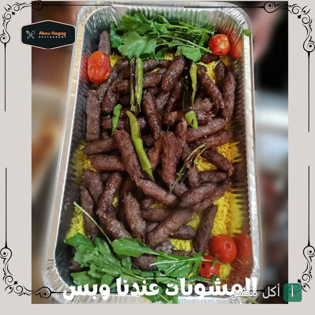 علبة مشويات تحتوي على كفتة مشوية مع أرز أصفر وفلفل أخضر وطماطم من مطعم أبو الحاج في العامرية.