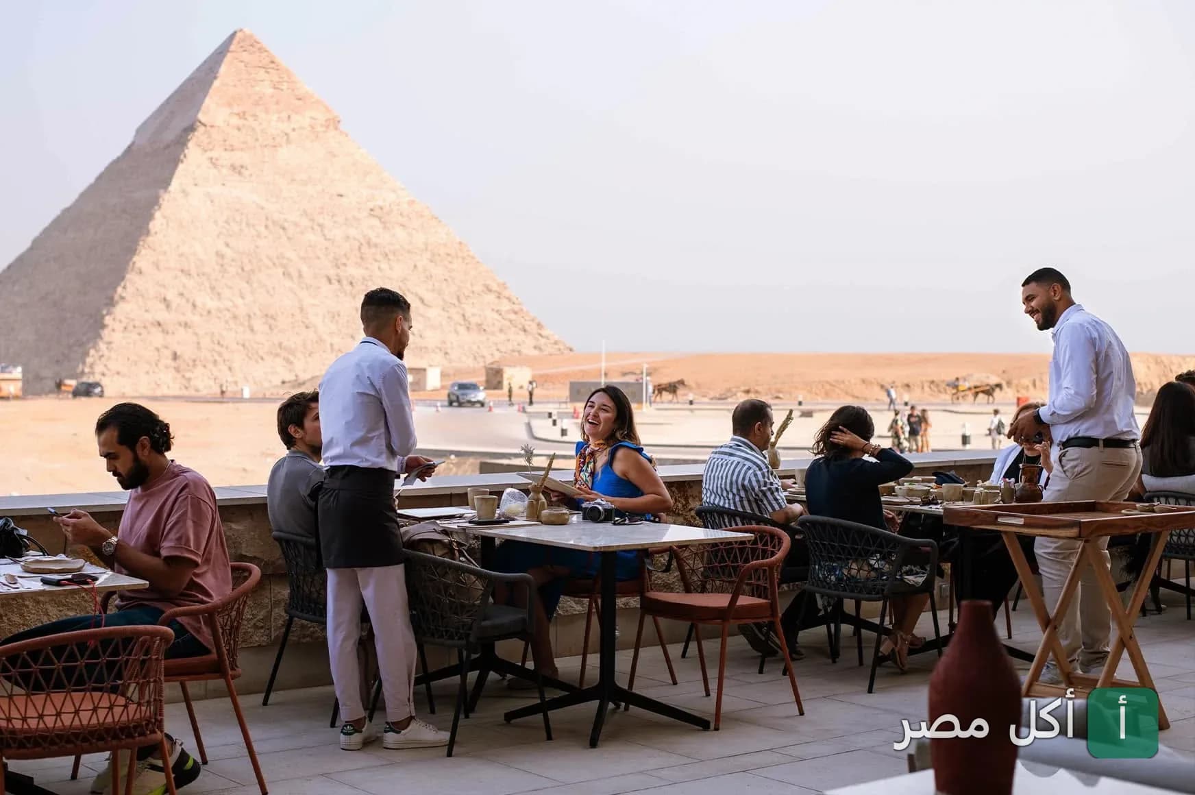 جلسة خارجية في مطعم خوفو بنزلة السمان مع إطلالة مباشرة على أهرامات الجيزة.