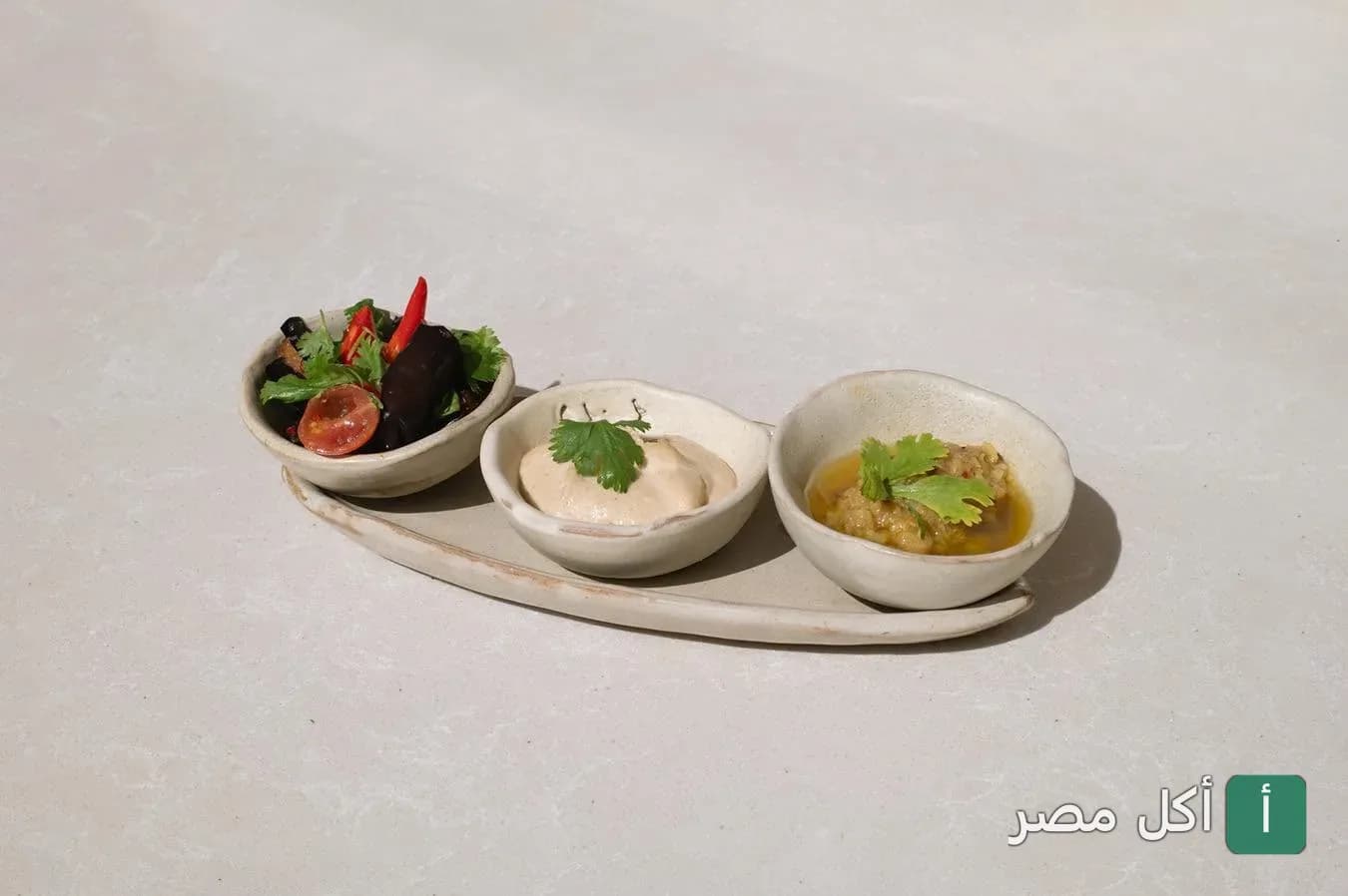 ثلاثة أطباق مقبلات صغيرة متنوعة في مطعم خوفو بالجيزة.