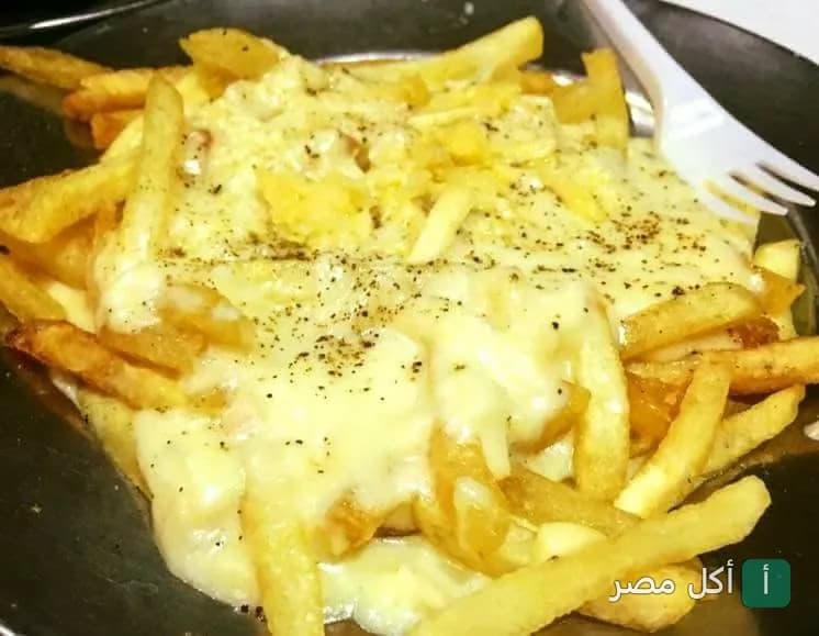 بطاطس مقلية مغطاة بصوص الجبنة السايحة في مطعم ألبان سويسرا بالإسكندرية.