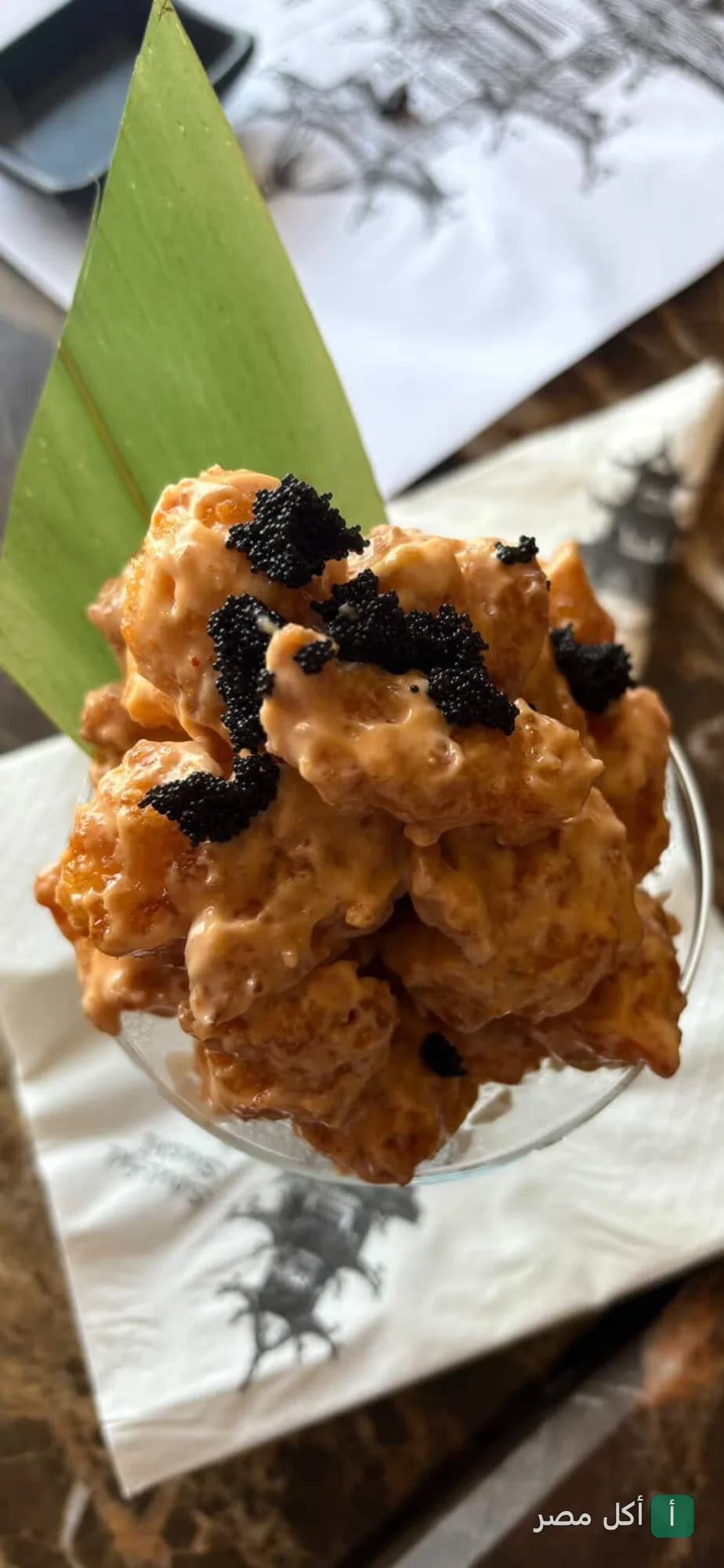 طبق جمبري مقلي بصوص المايونيز الحار مع الكافيار الأسود في مطعم أريجاتو بـ 6 أكتوبر.