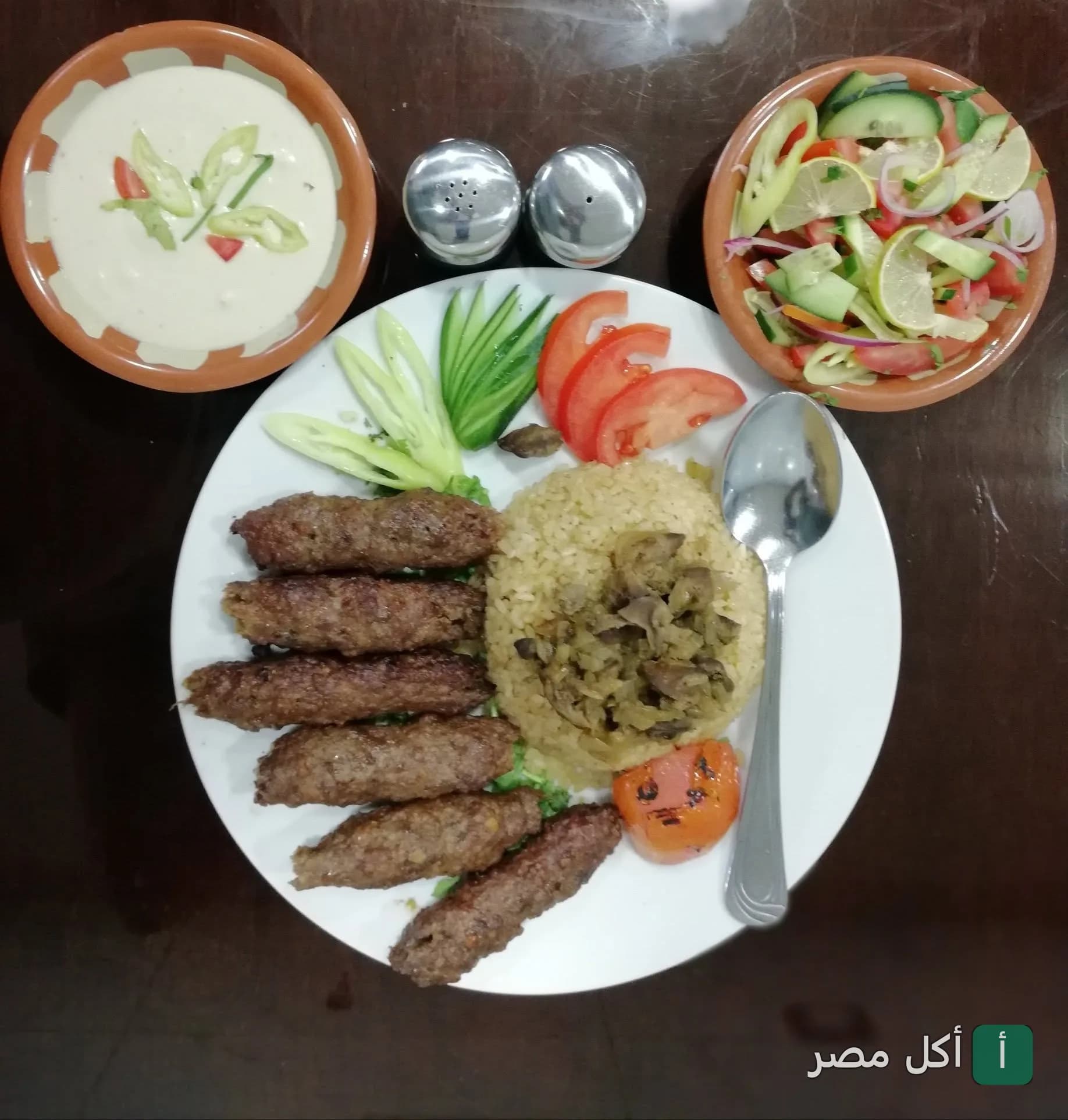 طبق كفتة مشوية مع أرز وسلطة وطحينة في مطعم الحلال بالأهرام.
