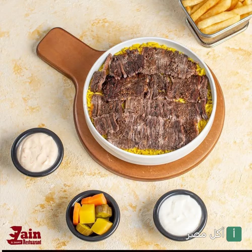 طبق شاورما لحم على أرز أصفر مع بطاطس ومقبلات في مطعم زين الشام بإمبابة