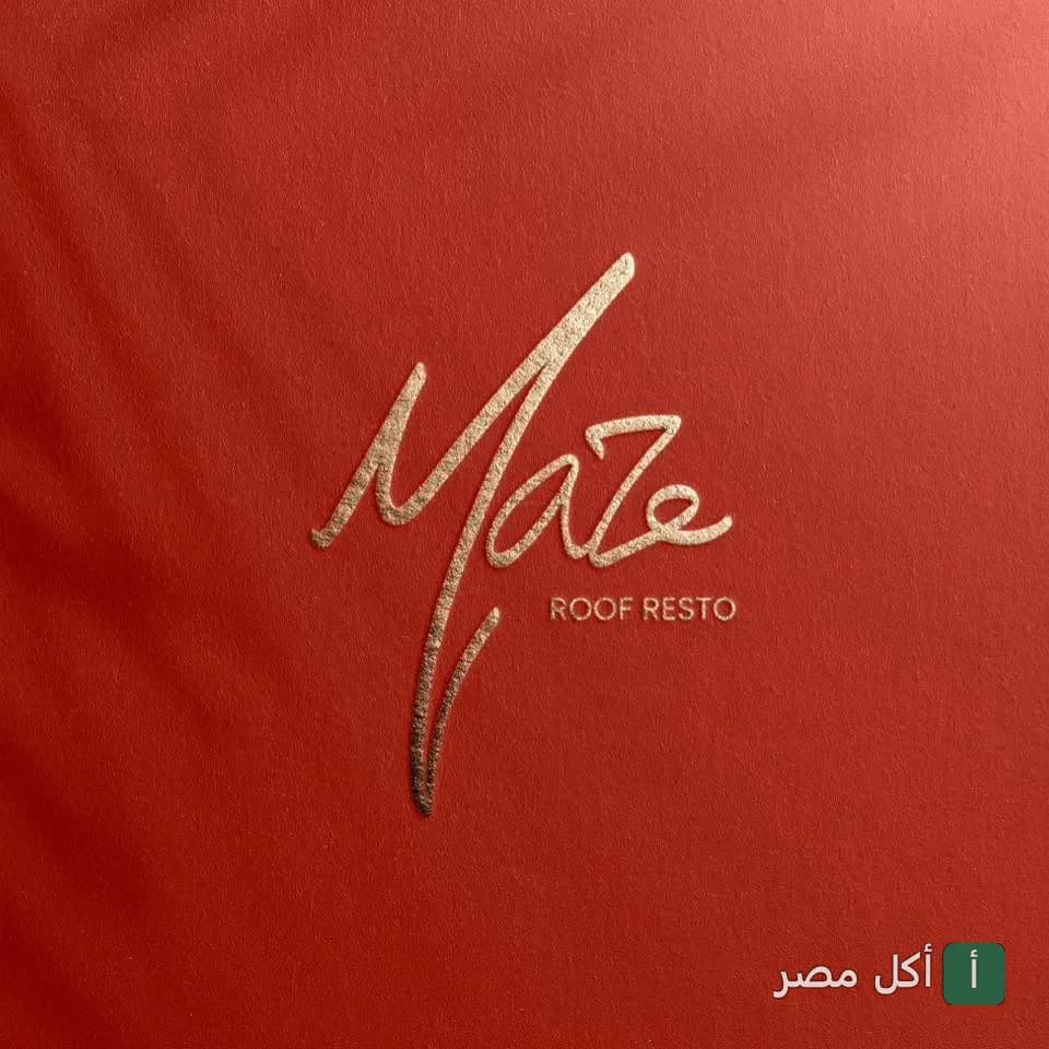 شعار مطعم Maze Roofresto باللون الذهبي على خلفية حمراء.