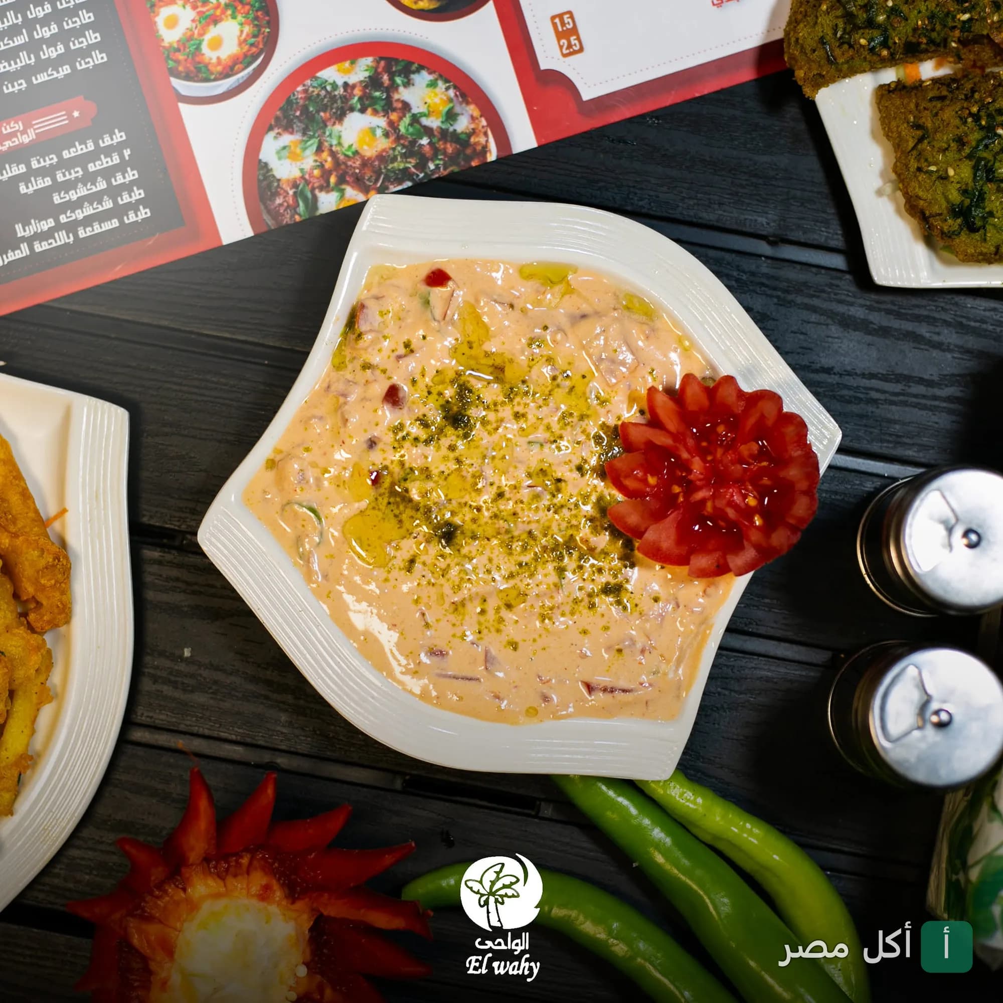 طبق جبنة بالطماطم مزين بوردة طماطم في مطعم الواحي بالمقطم