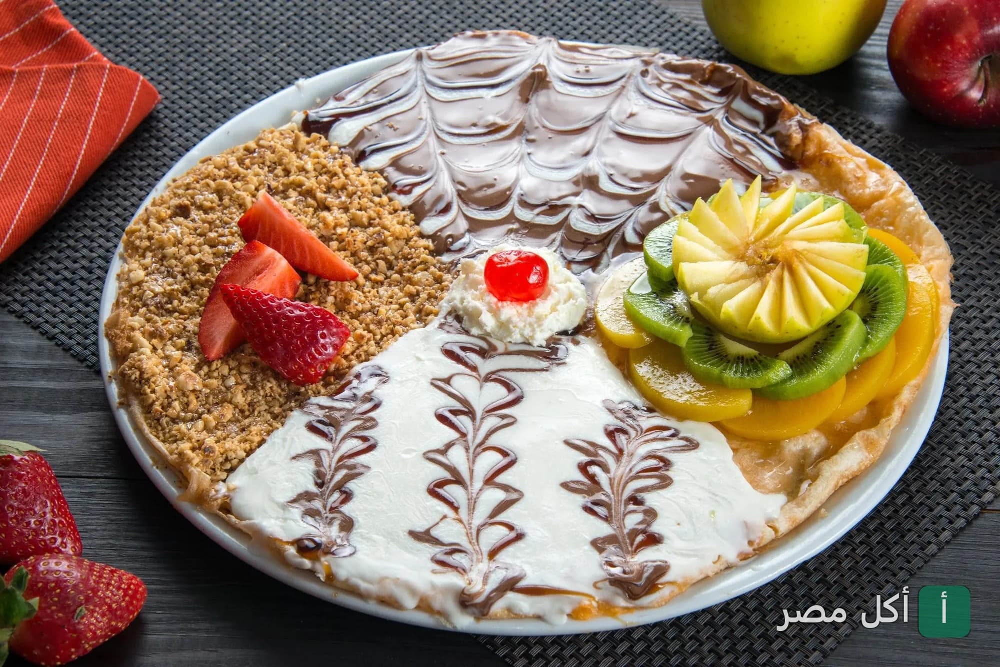طبق حلوى مقسم بأربع نكهات مختلفة من الشوكولاتة والفواكه والمكسرات في مطعم تيستيبيستي بالجيزة.