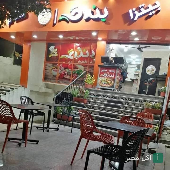 واجهة مطعم بيتزا بندق في الخليفة مع جلسات خارجية وكراسي ملونة