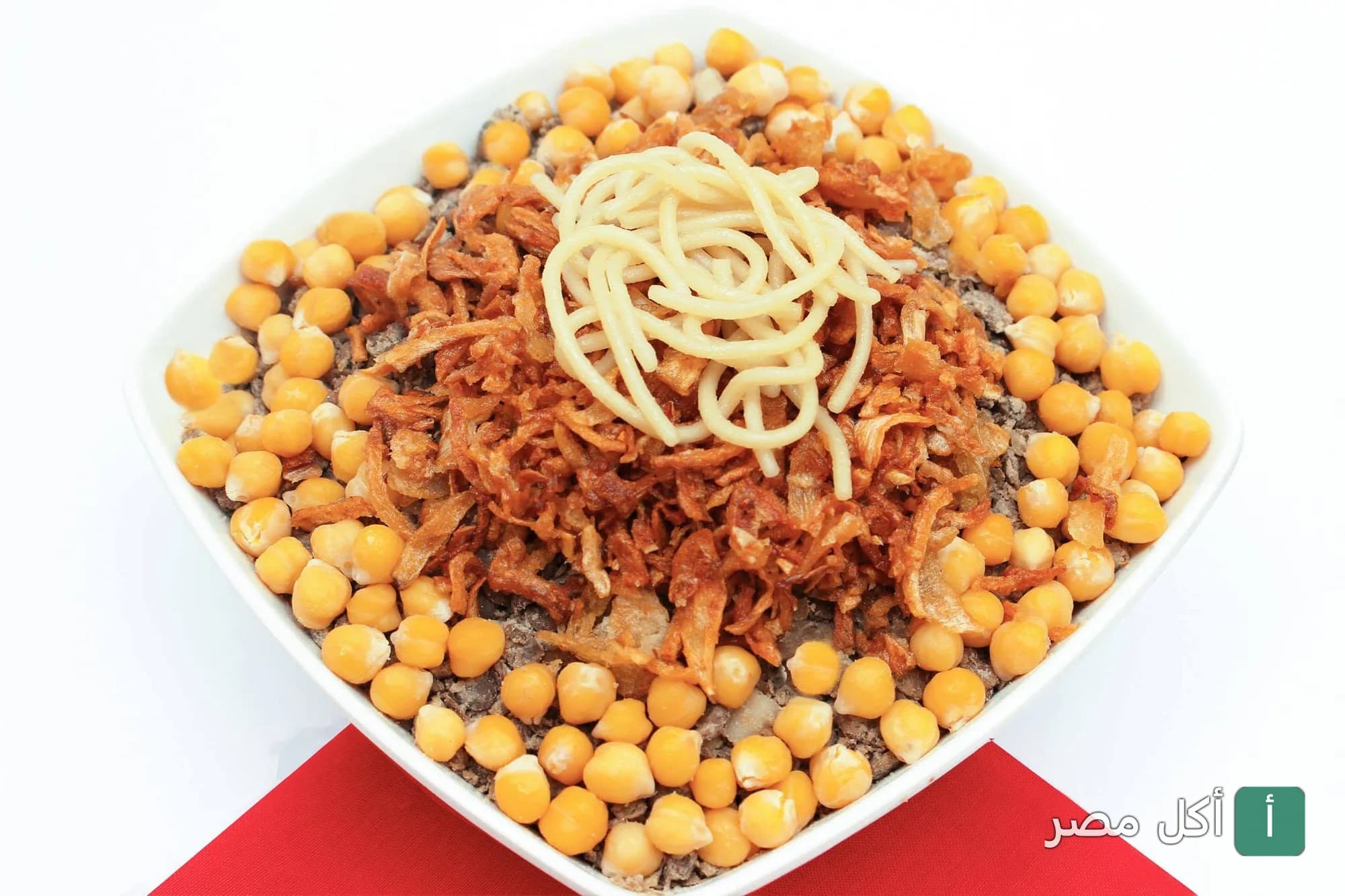 طبق كشري مصري غني بالحمص والبصل المقرمش من مطعم كشري الباشا في إمبابة.