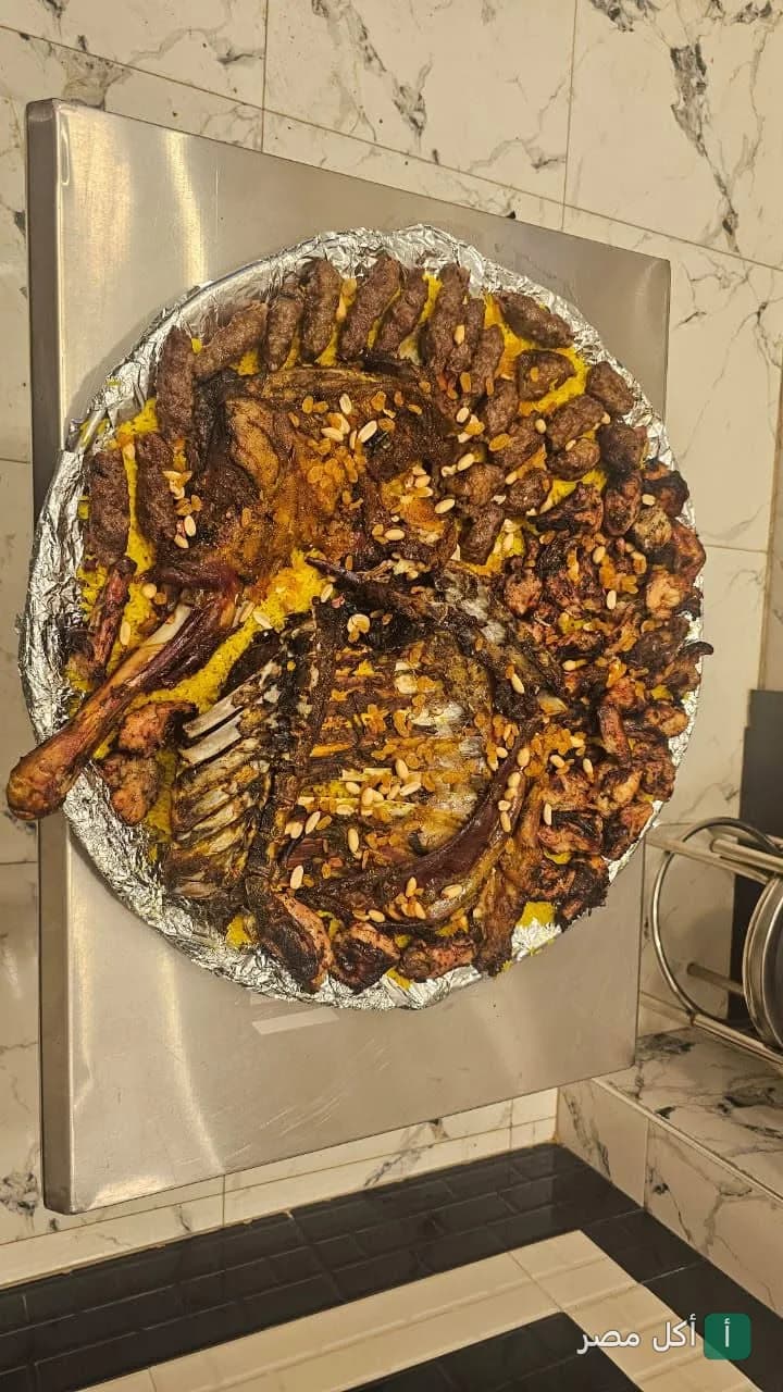 صينية مشويات كبيرة تضم كباب وكفتة وريش على أرز أصفر في كبابجي الصفا والمروة بإمبابة.