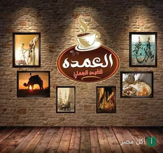 لوحة شعار مطعم كبده جملي العمده في كرداسة معلق على حائط حجري مزين بصور تراثية.