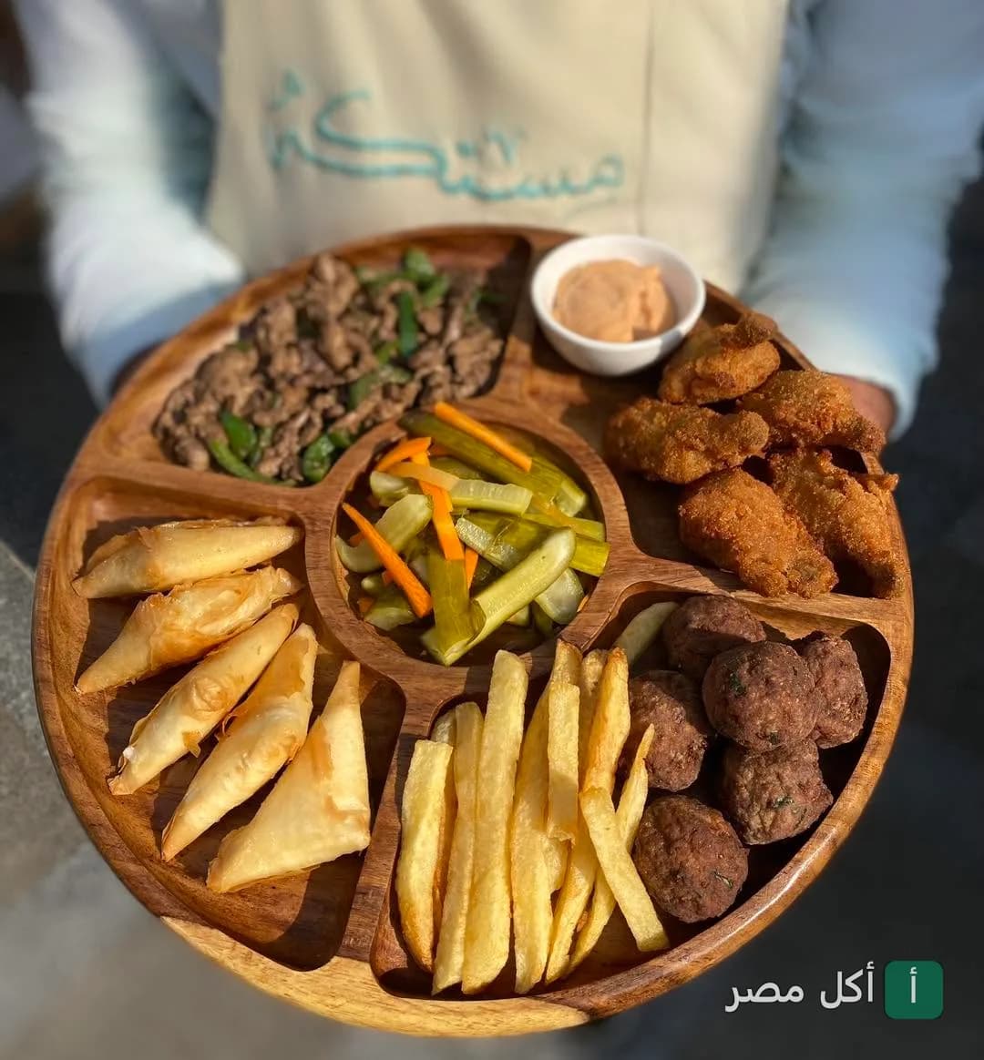 طبق مقبلات مشكل يضم سمبوسك، كفتة، بطاطس مقلية، وشرائح مخلل في برنسيس كافيه بوينت 6 مول بالشيخ زايد.