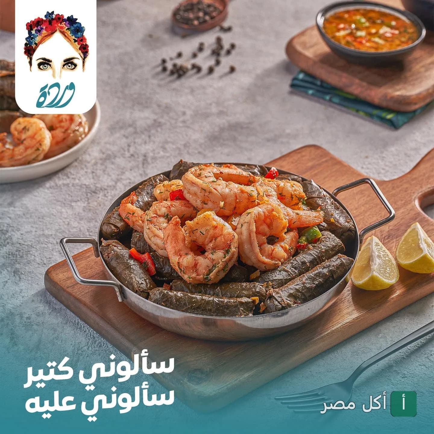 طبق ورق عنب بالجمبري مقدم في طاسة معدنية على لوح خشبي في كافيه وردة بالوراق.