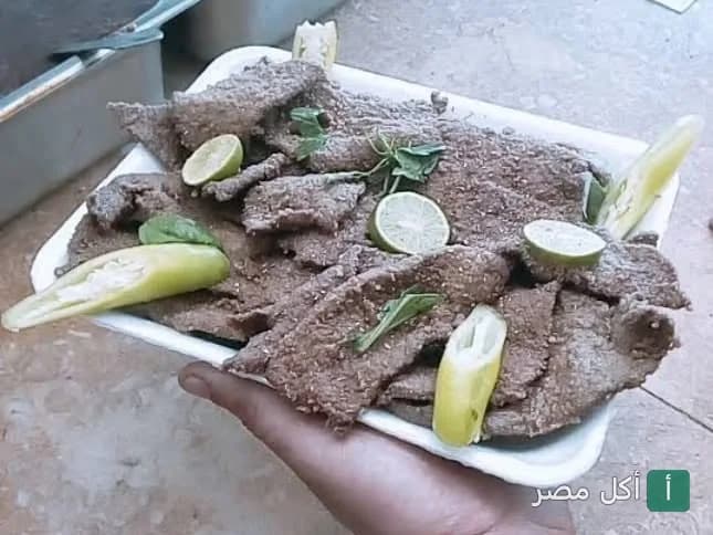 طبق كبدة مشوية مزينة بالليمون والفلفل الأخضر من مطعم نص كبده بالأهرام