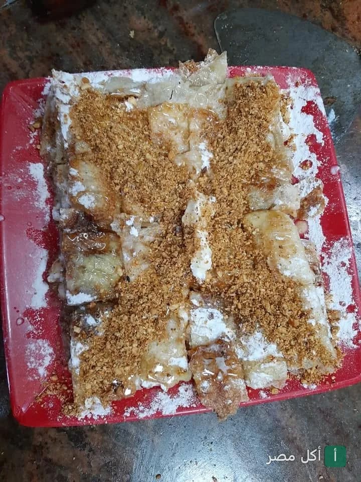 فطير حلو بالسكر والمكسرات في طبق أحمر من فطير القلاع بسموحة، الإسكندرية.