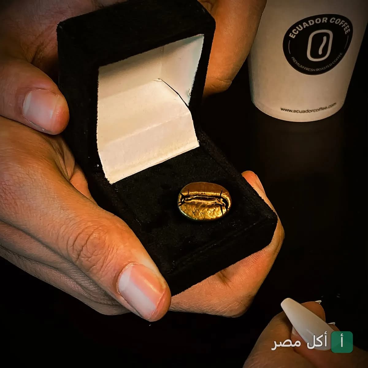حبة قهوة ذهبية داخل علبة مخملية في إكوادور كوفي بشارع فؤاد بالإسكندرية.