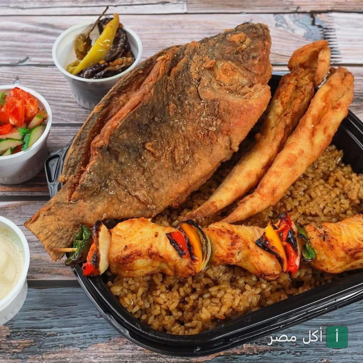 وجبة سمك مقلي مع أرز صيادية وشيش طاووق ومقبلات من مطعم الفرسان في مينا البصل بالإسكندرية.